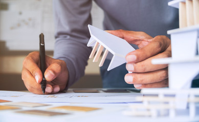 architect design working drawing sketch plans blueprints and making architectural construction model in architect studio