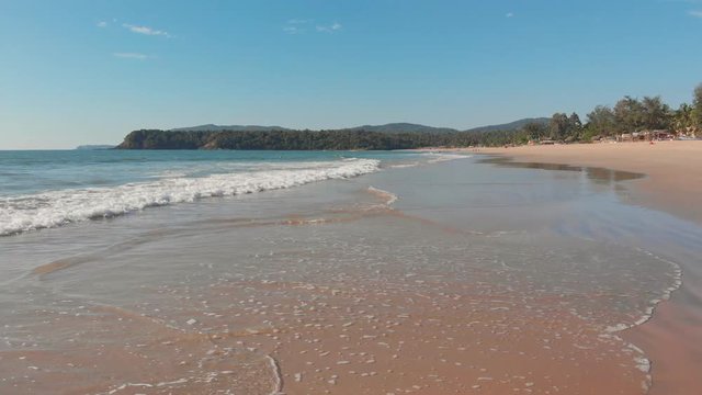 Low drone flight over the waves of Agonda beach. Goa State. India.