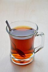 cup of Turkish tea with spoon on wooden background