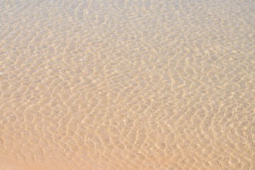 Little waves in the shallow water at the beach