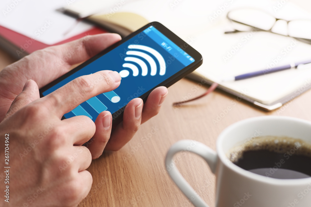 Poster setting wifi of smart phone.closeup of male hands touching smartphone screen at table.