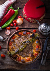 Minced meat kebab in a pot with vegetables and bread