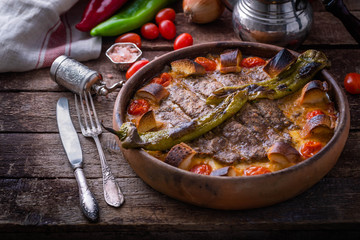 Minced meat kebab in a pot with vegetables and bread