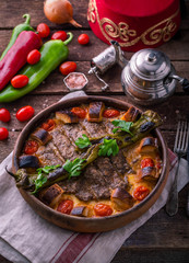 Turkish kebab in a ceramic pot with vegetables