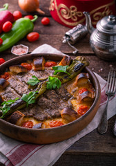 Minced meat kebab in a pot with vegetables and bread