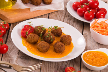 Meatballs with mashed carrots.