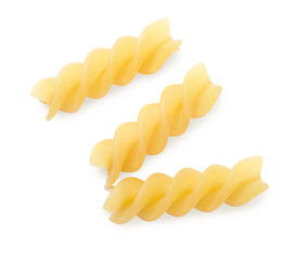 Three raw italian yellow pasta torti isolated on white background. Top view.