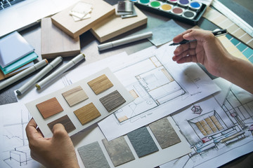 Architect designer Interior creative working hand drawing sketch plan blue print selection material...