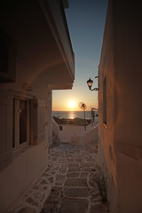 Typical street of Parikia overlooking the Gulf of Parikia at sunset