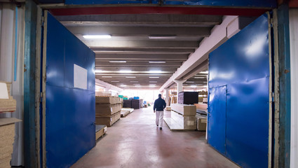 carpenter walking through factory