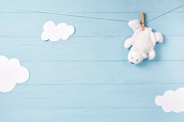 Fototapeten Baby boy background with white teddy bear toy on a clothesline and clouds © pavkis