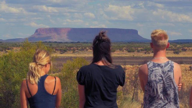 Group of friends enjoying view of Mount Conner with semi cloudy sky and sunny view.