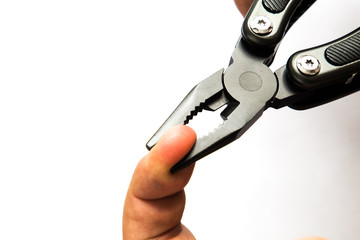 Black crocodile mouth pliers holding a finger. white background