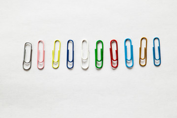 Top view mix colorful paper clips on white background.