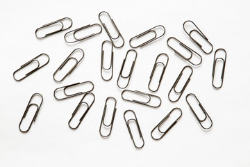silver paper clips on white background