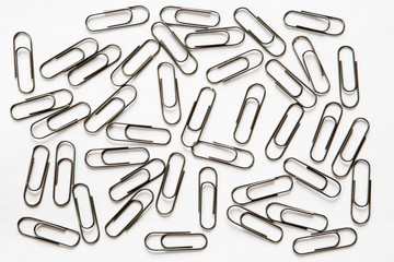 silver paper clips on white background