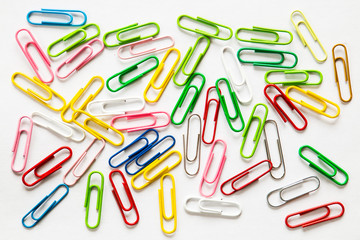 Top view mix colorful paper clips on white background.