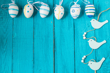Colorful Easter Eggs arranged to one side on a blue background.