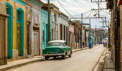 Naklejka na ściany i meble Old living houses across the road in the center of Santiago De Cuba, Cuba