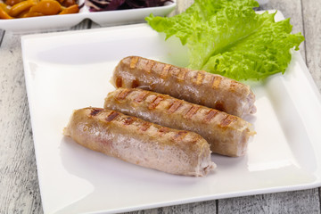 Grilled sausages served mushrooms and cabbage