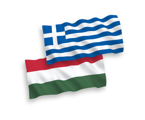 National vector fabric wave flags of Greece and Hungary isolated on white background. 1 to 2 proportion.