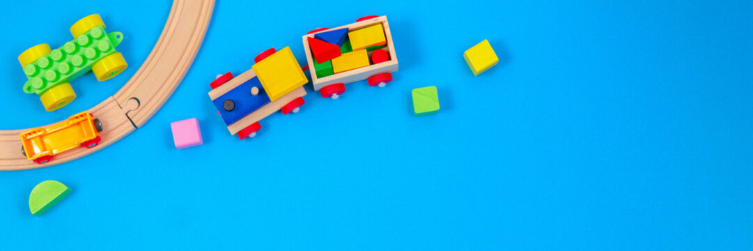 Baby kid toy background. Wooden toy train with colorful blocks on blue background