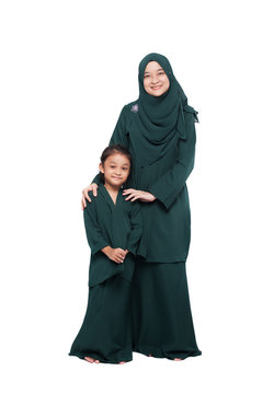 Malay mother and daughter in traditional dress posing