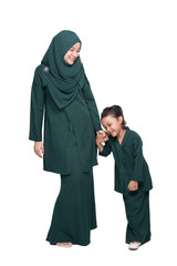 Malay mother and daughter in traditional dress posing