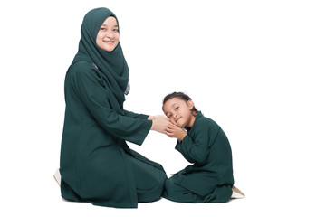 Daughter asking for forgiveness from mother during Raya, a muslims festive celebration