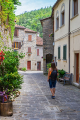 Tourist on a narrow old street in Italy