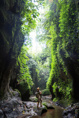 Woman near waterfal on Bali, Indonesia 