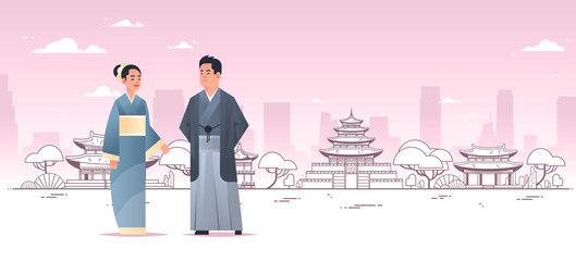 asian couple wearing traditional clothes man woman in ancient costume standing together chinese or japanese characters over pagoda buildings landscape background full length horizontal