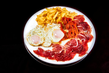Dish with egs ham, potatoes and  red peppers