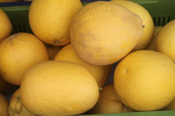 Pile of ripe pomelos in a box