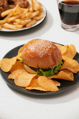 Fast food hamburger with set fried crispy chicken and french fries, ice cola on the side