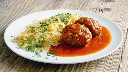 beef patties with fried white cabbage decorated with dill
