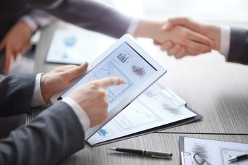 close up.Businessman uses digital tablet to check financial profit