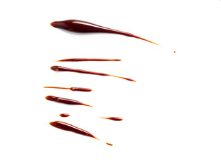 Chocolate sauce on white. Abstract lines made of chocolate or soy sauce isolated on white background