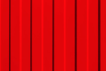 The surface of the metal profiled panel in red close-up. Background.