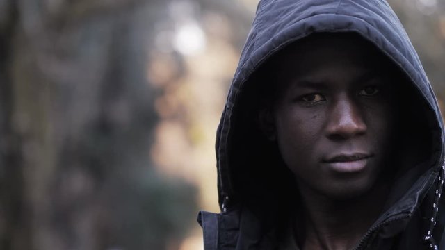Proud Confident hooded black african young man staring at camera-outdoor