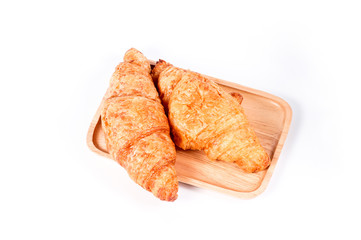 Top view of croissant. Croissant on wooden plate. fresh and tasty croissants isolated on a white background