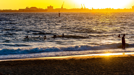 An unidentified group of people are taking a late afternoon swim in Port Phillip Bay, Melbourne,...