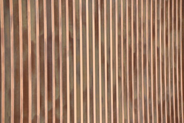 A wall of rusty steel beams.