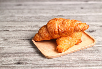 Coissant. fresh and tasty croissants on wooden table 