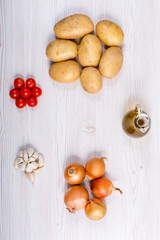 Fresh vegetables ingredients on white wood background