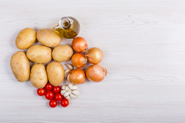 Fresh vegetables ingredients on white wood background