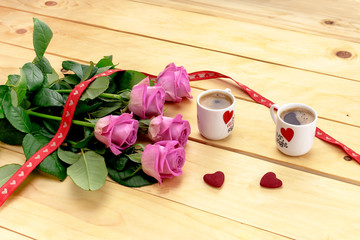 Bouquet of roses and two cups of coffee