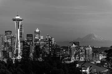 Black and white image of the skyline of the city of Seattle and the profile of Mount Rainier in the background.