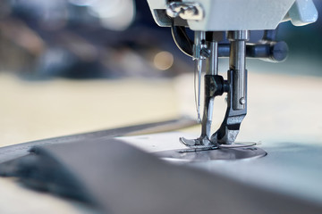 Industrial sewing machine with bokeh background