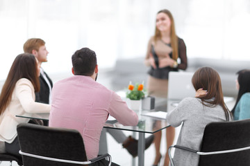 blurred image of a briefing in a modern office